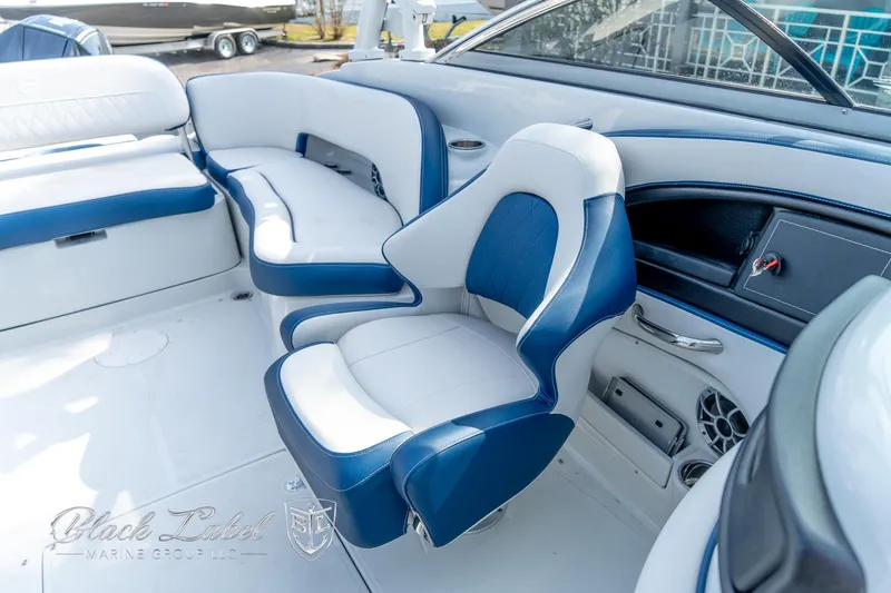 Slide: The Image of 2024 Crownline E260 XS boat interior with blue and white seating, showcasing luxury design. - 19