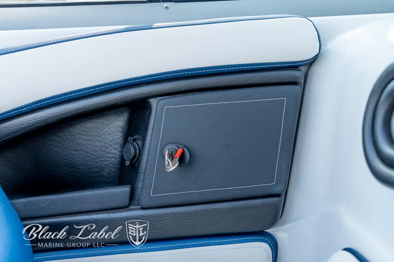 Slide: The Image of 2024 Crownline E260 XS boat dashboard with key ignition and Black Label Marine Group logo. - 20
