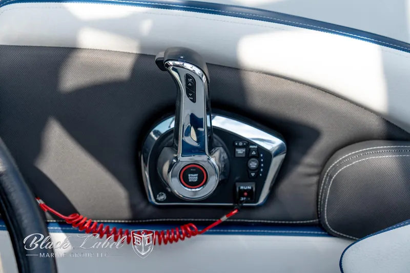 Slide: The Image of Throttle control of 2024 Crownline E260 XS boat with sleek chrome finish. - 23