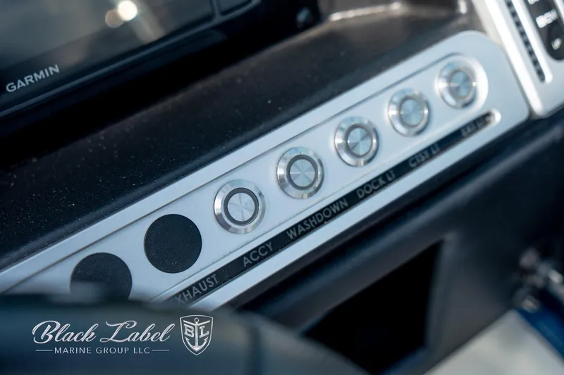 Slide: The Image of Control panel of 2024 Crownline E260 XS boat with labeled switches. - 26