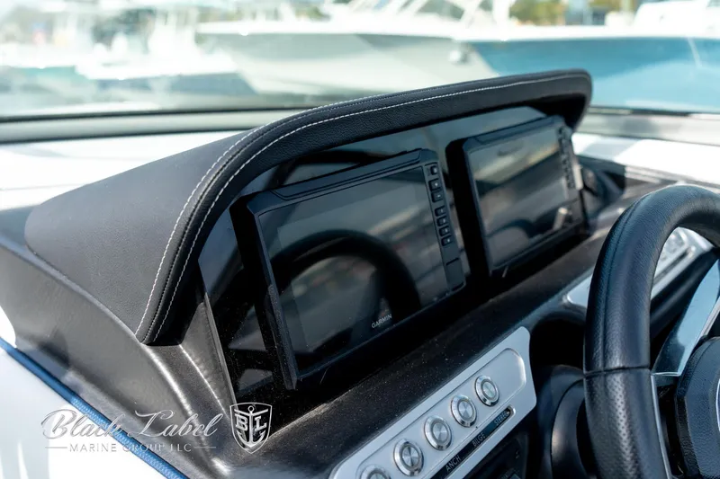 Slide: The Image of 2024 Crownline E260 XS dashboard with dual displays and steering wheel. - 27