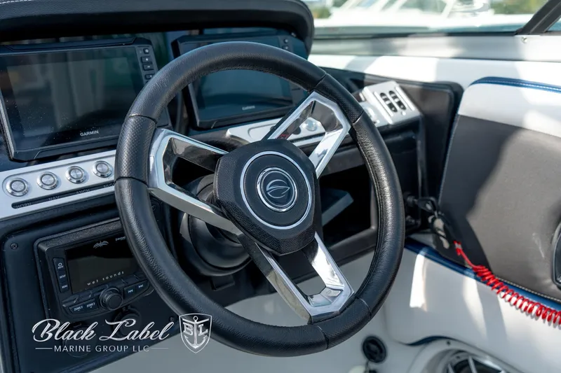 Slide: The Image of 2024 Crownline E260 XS boat steering wheel and dashboard, featuring modern controls and displays. - 28