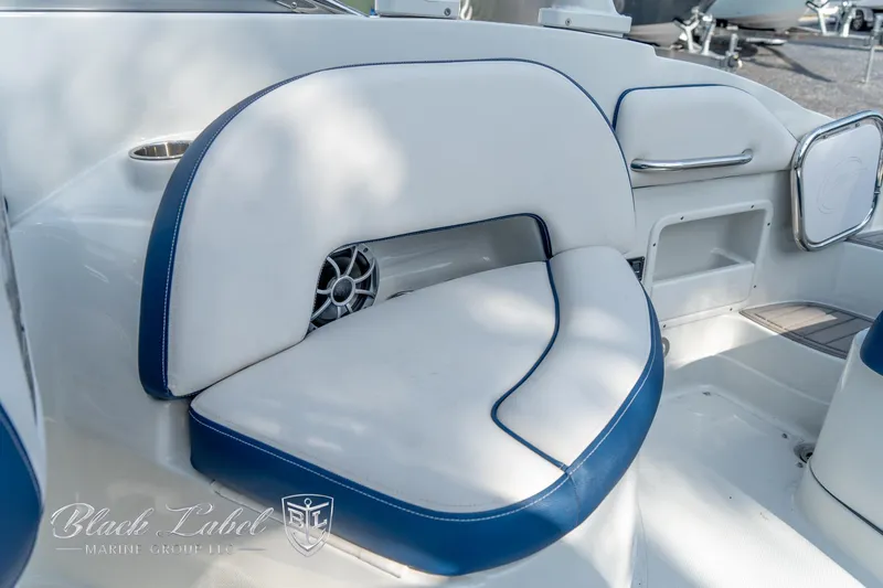 Slide: The Image of 2024 Crownline E260 XS boat interior with white and blue seating. - 29