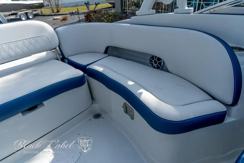 Slide: The Image of 2024 Crownline E260 XS boat interior with white and blue seating. - 30
