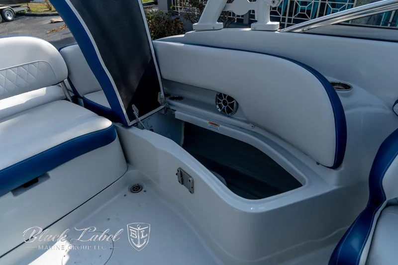 Slide: The Image of 2024 Crownline E260 XS boat interior with open storage compartment and cushioned seating. - 31