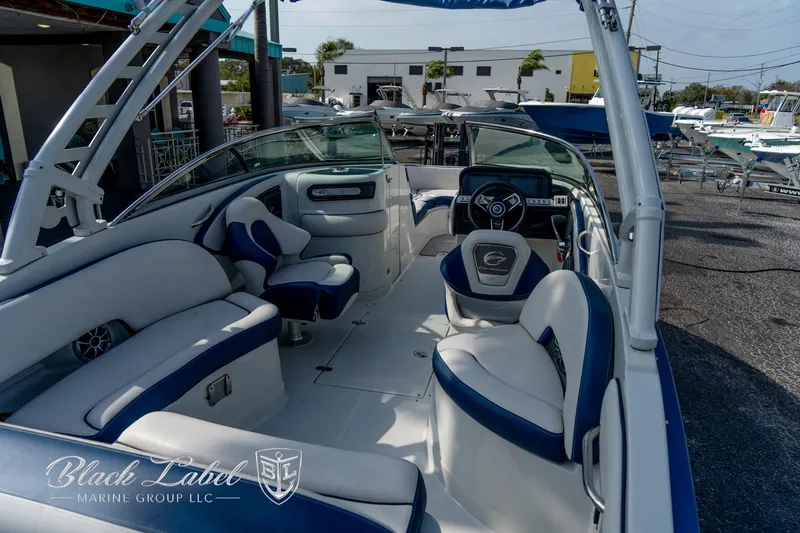 Slide: The Image of 2024 Crownline E260 XS boat interior with blue and white seating, steering wheel, and modern design. - 35