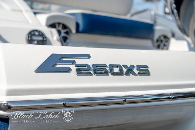 Slide: The Image of 2024 Crownline E260 XS boat logo with sleek design details. - 6