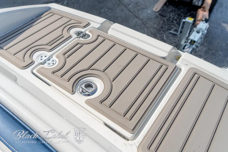 Slide: The Image of 2024 Crownline E260 XS boat deck with tan non-slip surface and sleek design. - 8