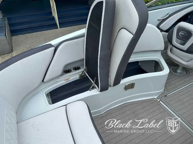 Slide: The Image of 2024 Crownline E280 XS boat interior with storage compartment and seating. - 18