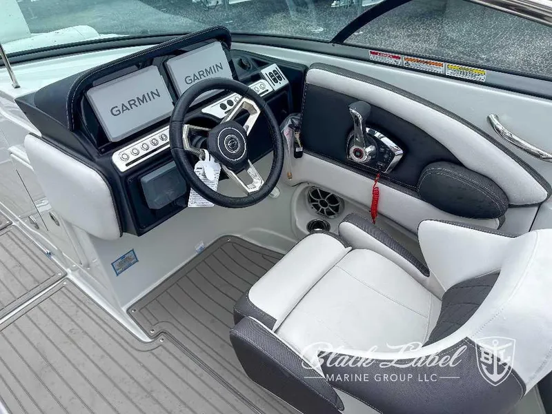 Slide: The Image of 2024 Crownline E280 XS boat cockpit with Garmin navigation system and luxurious seating. - 2