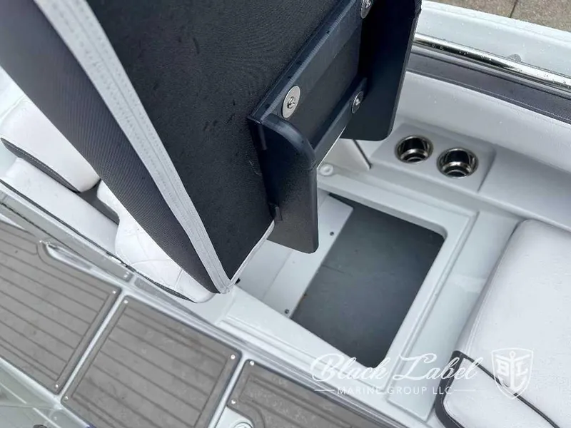 Slide: The Image of 2024 Crownline E280 XS boat interior with storage compartment and cup holders. - 5