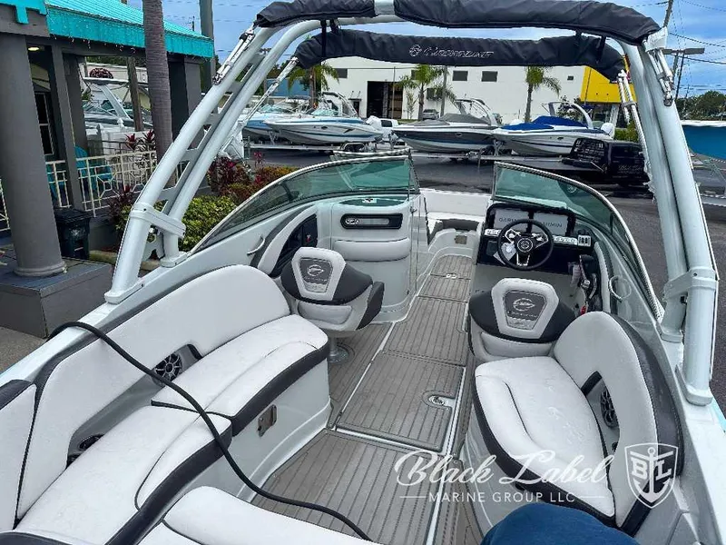 Slide: The Image of 2024 Crownline E280 XS boat interior with seating and steering console. - 7