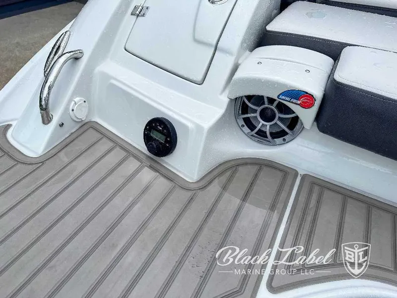 Slide: The Image of 2024 Crownline E280 XS boat deck with speaker and seating, Black Label Marine Group logo. - 9