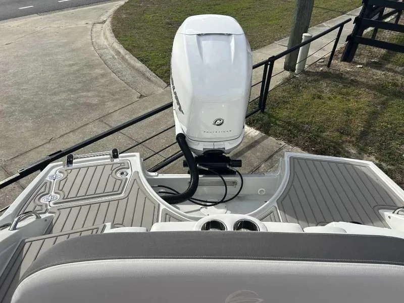 Slide: The Image of 2024 Crownline E280 XS boat with outboard motor, rear deck view. - 12