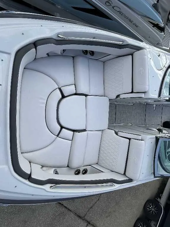Slide: The Image of 2024 Crownline E280 XS boat with luxurious white seating and spacious layout. - 3
