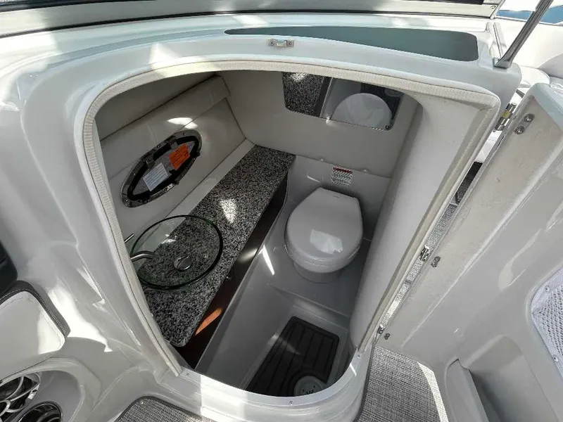 Slide: The Image of 2024 Crownline E280 XS boat bathroom with modern fixtures and granite countertop. - 6