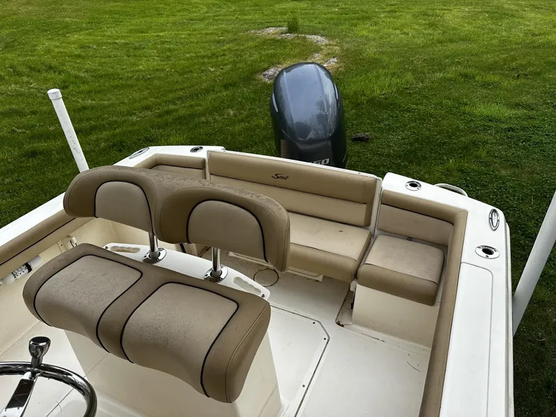 Slide: The Image of 2018 Scout 225 XSF boat interior with seating and outboard motor. - 3