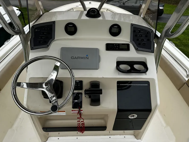 Slide: The Image of 2018 Scout 225 XSF boat dashboard with Garmin navigation system and steering wheel. - 4
