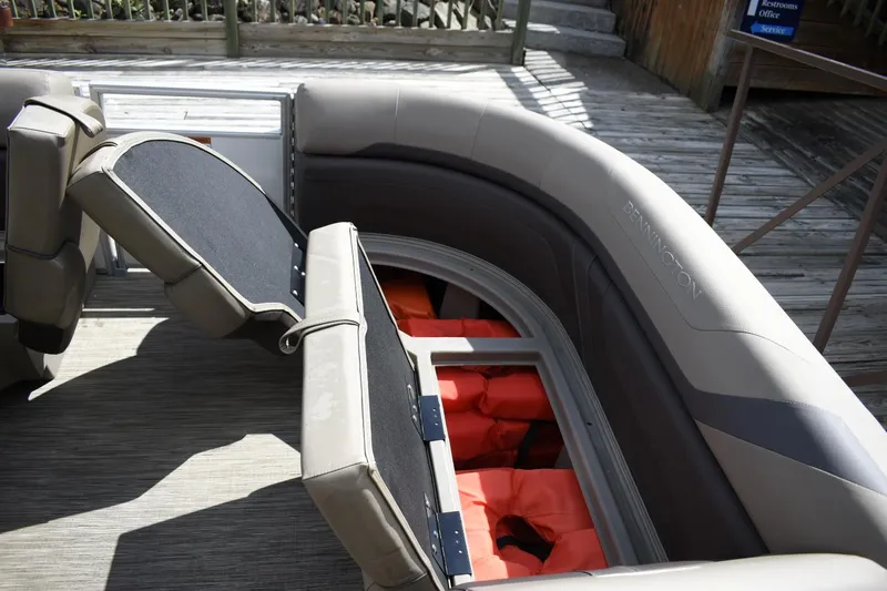Slide: The Image of 2023 Bennington 22 SXCW boat interior with storage compartments and life jackets. - 7