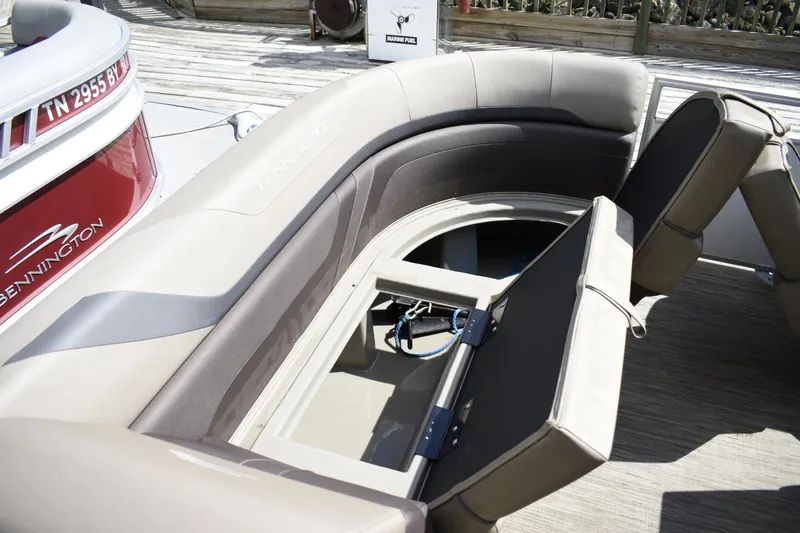Slide: The Image of 2023 Bennington 22 SXCW boat with open storage compartment and seating. - 8