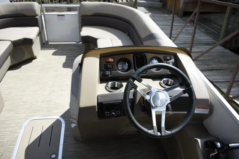 Slide: The Image of 2023 Bennington 22 SXCW pontoon boat interior with steering console and seating. - 9