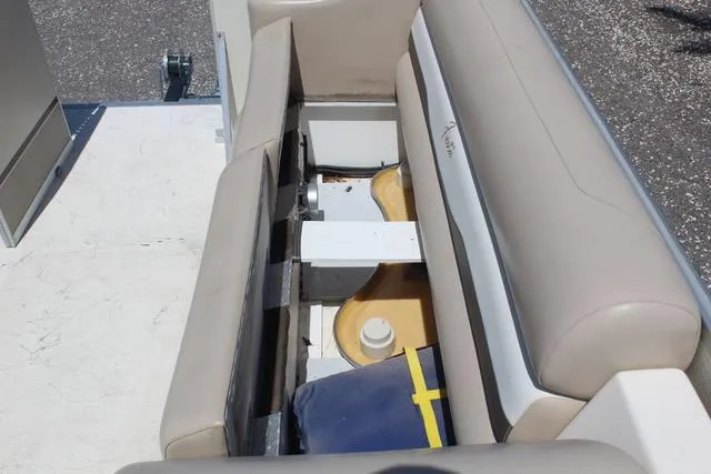 Slide: The Image of 2013 Fiesta 22 Fundeck boat interior storage compartment with beige seating. - 14