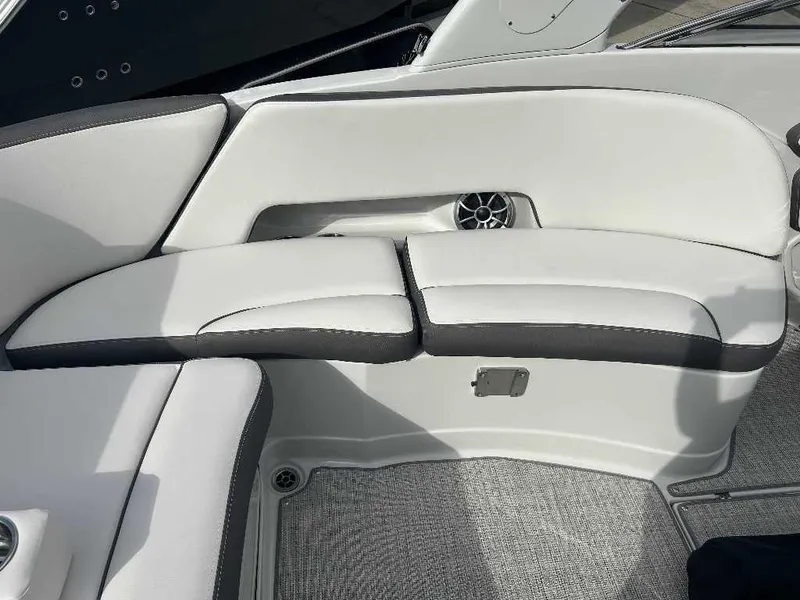 Slide: The Image of 2024 Crownline E280 XS boat interior seating with white and black upholstery. - 11
