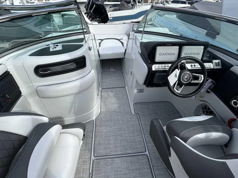 Slide: The Image of 2024 Crownline E280 XS boat interior with Garmin navigation system and luxurious seating. - 5
