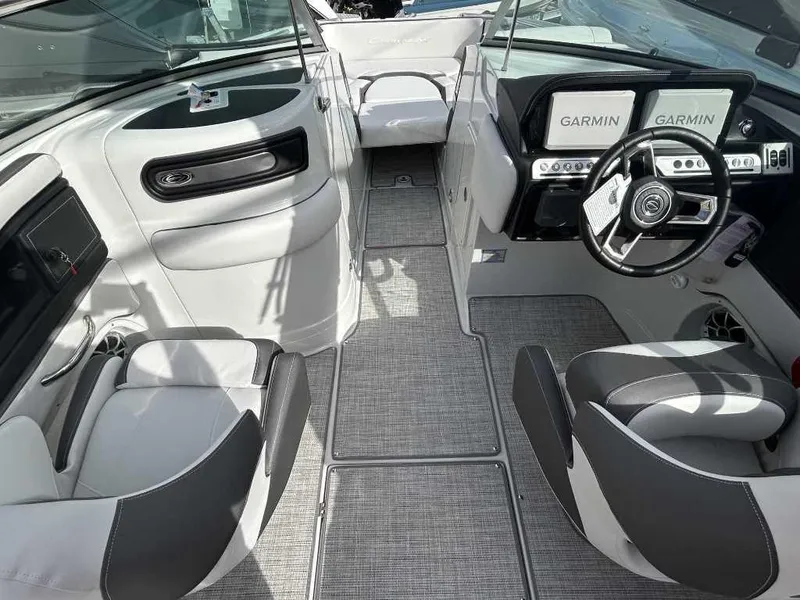Slide: The Image of 2024 Crownline E280 XS boat interior with Garmin navigation system and modern seating. - 7