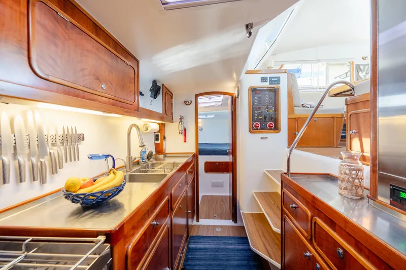 Slide: The Image of Luxurious 2009 Chris White Atlantic 57 yacht interior with modern kitchen and wooden cabinetry. - 12