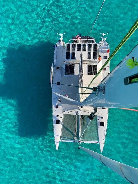 Slide: The Image of Aerial view of 2009 Chris White Atlantic 57 catamaran on clear turquoise water. - 3