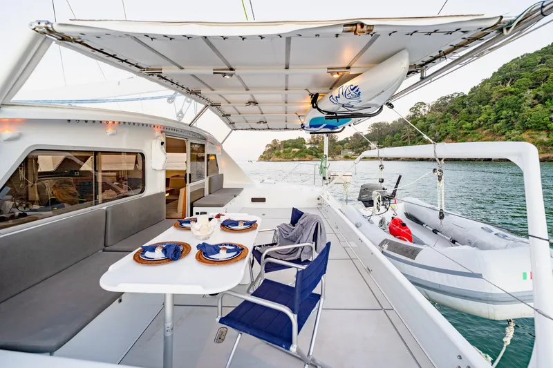 Slide: The Image of Luxury yacht deck with dining area, kayak, and tender boat, Chris White Atlantic 57, 2009 model. - 6