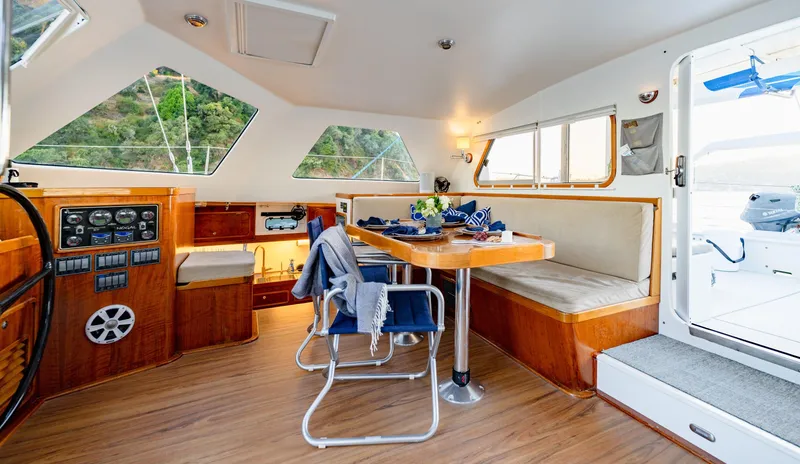 Slide: The Image of Luxurious interior of 2009 Chris White Atlantic 57 catamaran with dining area and navigation controls. - 7