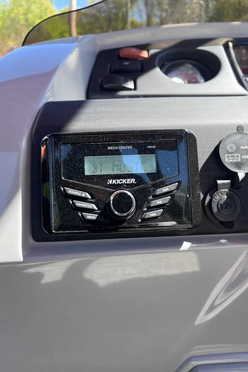 Slide: The Image of 2023 Bennington 23 SXSB dashboard featuring a Kicker audio system. - 10