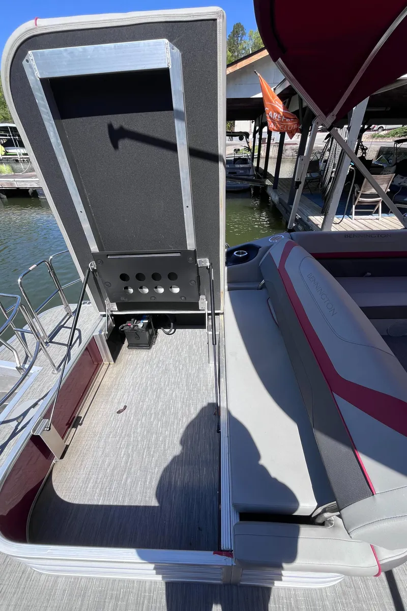 Slide: The Image of 2023 Bennington 23 SXSB pontoon boat interior with seating and storage compartment. - 8