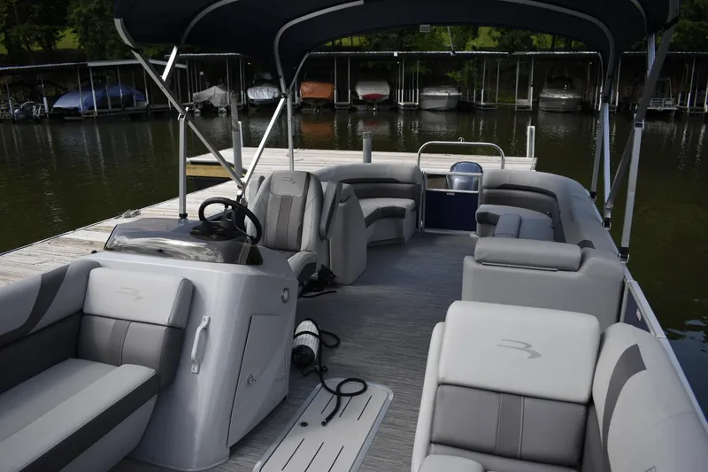 Slide: The Image of 2023 Bennington 23 SXSRC pontoon boat interior with gray seating and canopy. - 3