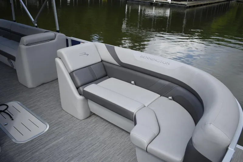 Slide: The Image of 2023 Bennington 23 SXSRC boat interior with luxurious seating by the water. - 4
