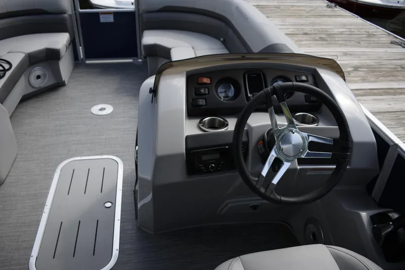 Slide: The Image of 2023 Bennington 23 SXSRC boat interior with steering wheel and seating. - 6