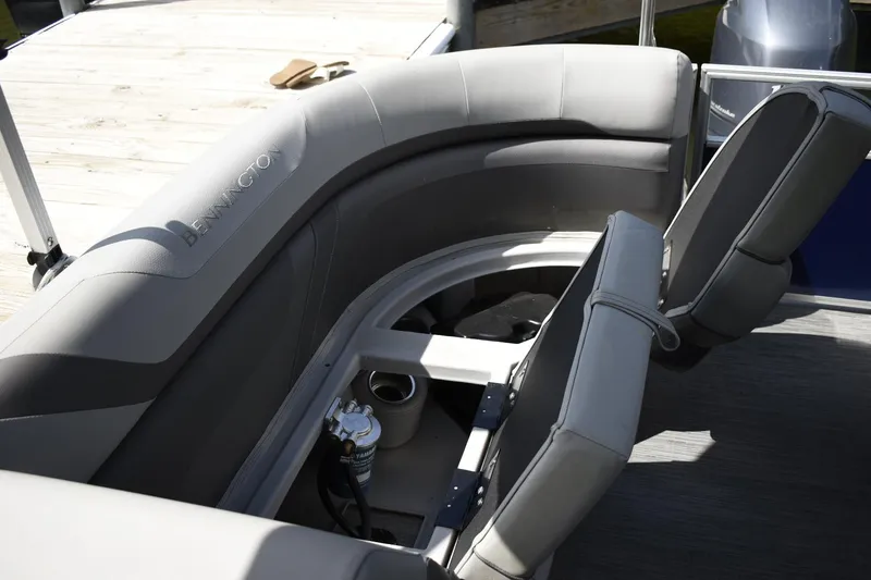 Slide: The Image of 2023 Bennington 23 SXSRC pontoon boat with gray seating and storage compartment. - 8