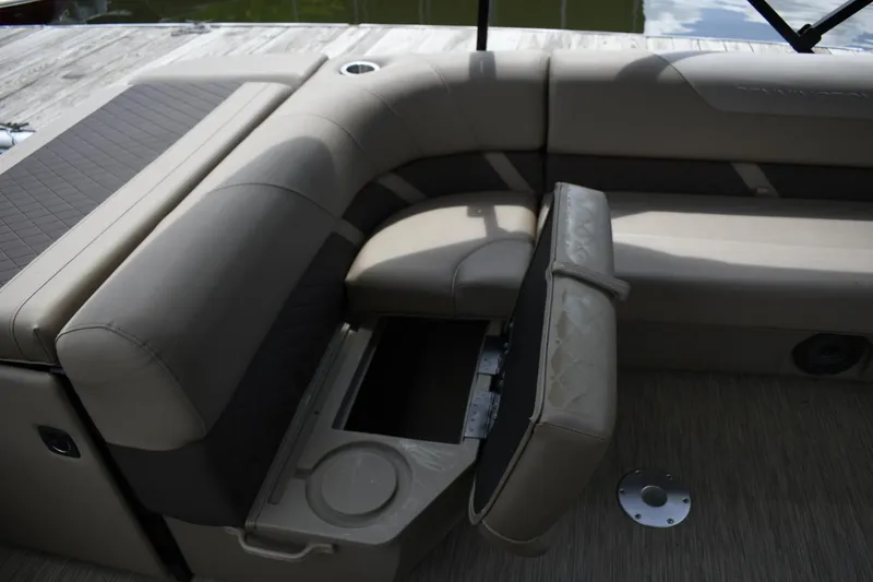 Slide: The Image of 2023 Bennington 23 XSL3 boat interior with storage compartment and cushioned seating. - 11