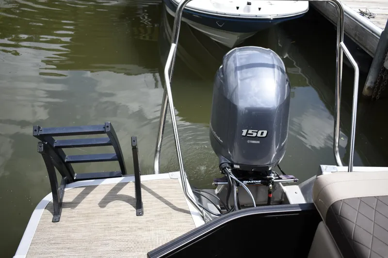 Slide: The Image of 2023 Bennington 23 XSL3 boat with Yamaha 150 outboard motor at dock. - 13
