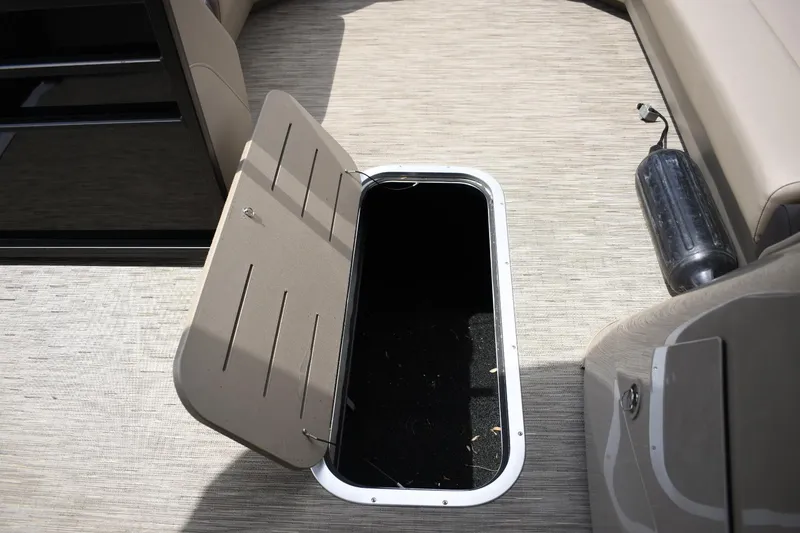 Slide: The Image of Open storage compartment on 2023 Bennington 23 XSL3 boat with beige interior. - 14