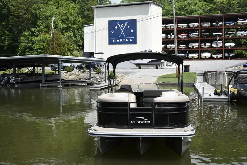 Slide: The Image of 2023 Bennington 23 XSL3 pontoon boat docked at Choto Marina. - 3