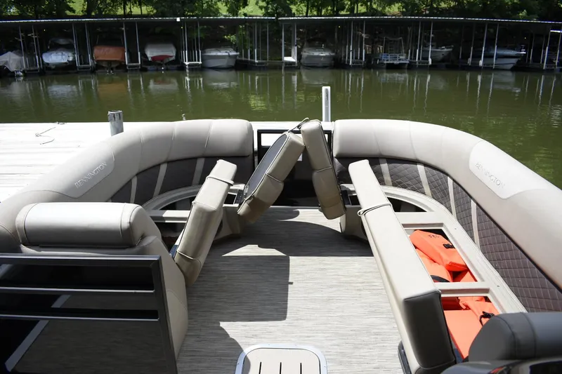 Slide: The Image of 2023 Bennington 23 XSL3 pontoon boat interior with plush seating and life jackets. - 5