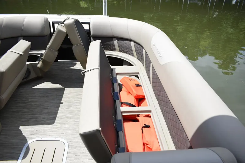 Slide: The Image of 2023 Bennington 23 XSL3 boat interior with storage compartments and life jackets. - 6