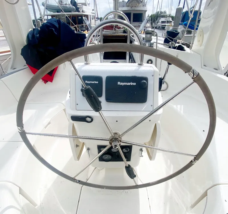 Slide: The Image of Steering wheel of a 1997 Hunter 430 sailboat with Raymarine equipment. - 11
