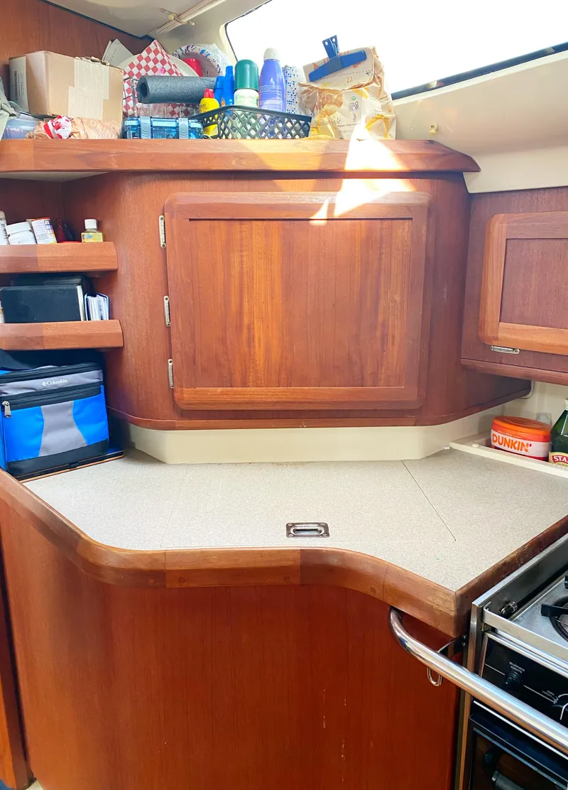 Slide: The Image of Hunter 430 yacht kitchen interior, 1997 model, featuring wooden cabinets and countertop. - 18
