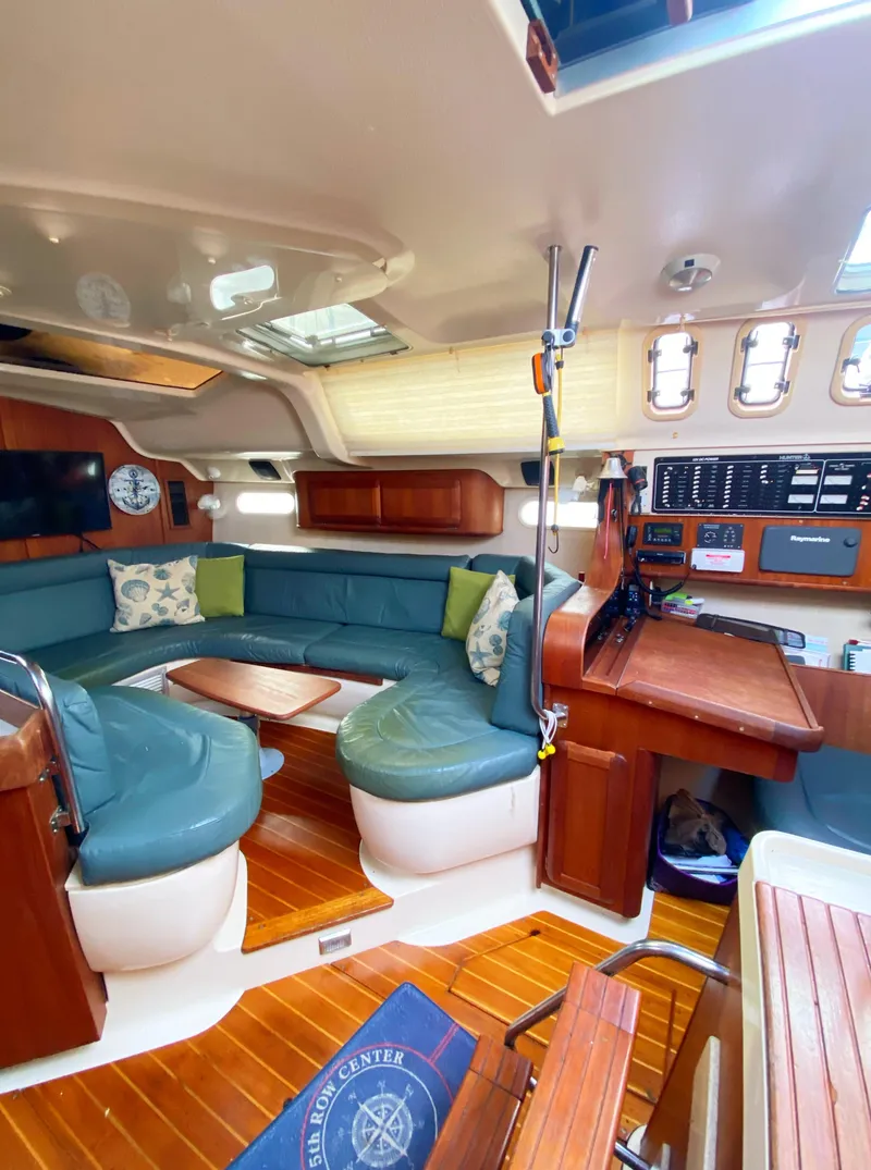 Slide: The Image of Interior of a 1997 Hunter 430 sailboat with cozy seating and wooden accents. - 24