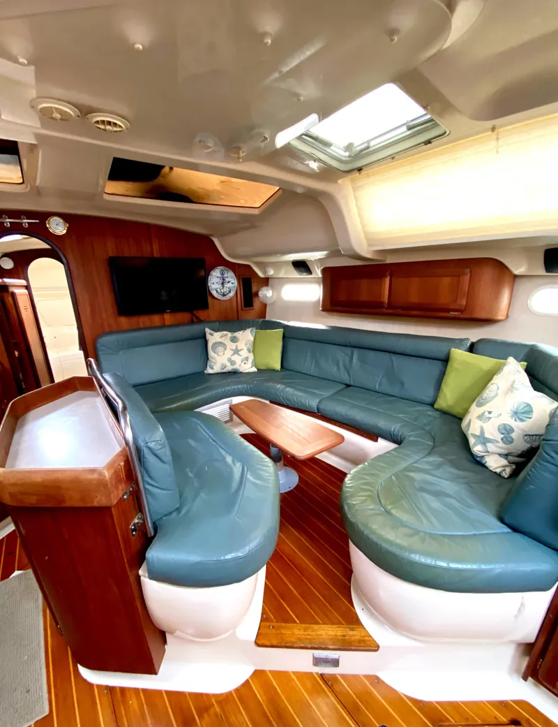 Slide: The Image of Interior of 1997 Hunter 430 yacht with blue seating and wooden accents. - 25