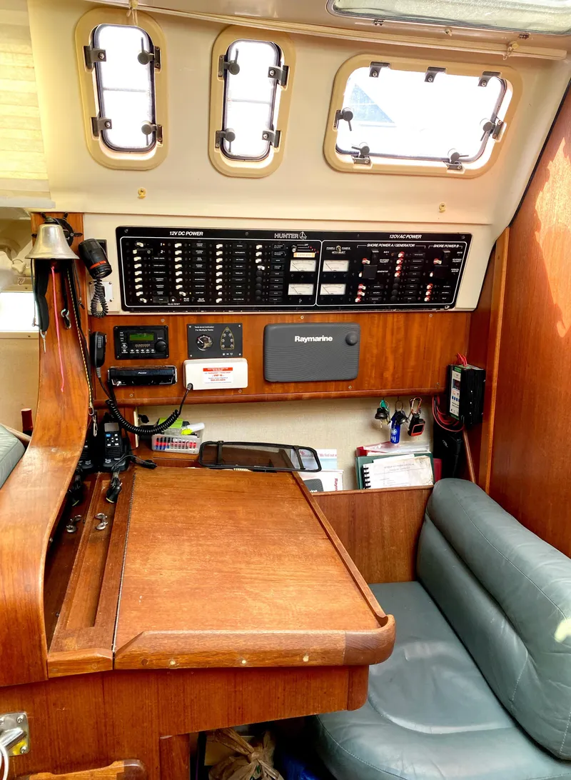 Slide: The Image of Interior of a 1997 Hunter 430 sailboat with navigation equipment and seating area. - 26